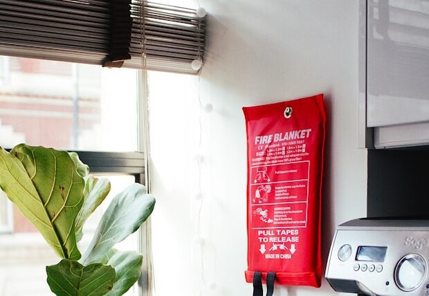 red and silver coffee maker beside white ceramic mug