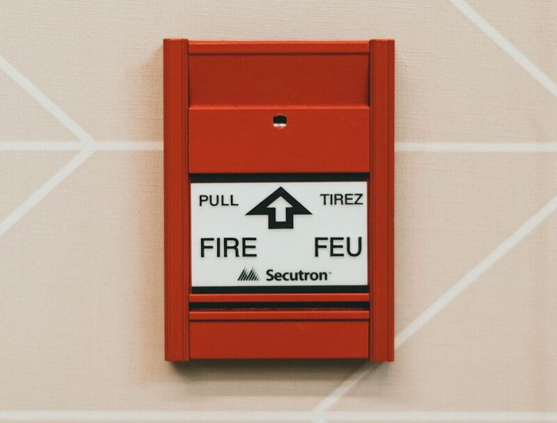 Dział instalacyjny a red fire extinguisher mounted to the side of a wall